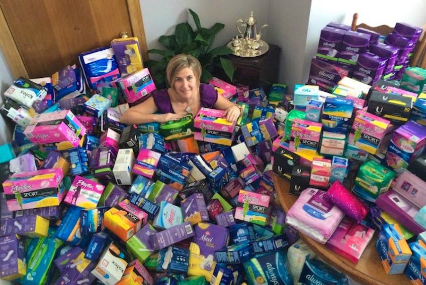 Tracey Comeau, organizer of Taking Care of Women's Business. Period. 28-day campaign, sits among more than a thousand boxes of feminine hygiene products destined for the shelves of P.E.I. food banks.