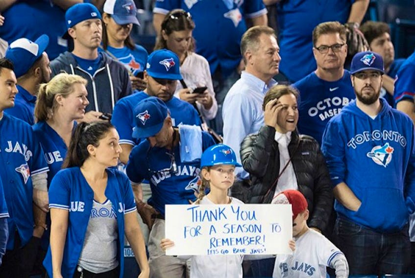 Toronto Blue Jays fans look on after the Cleveland Indians defeated the Blue Jays in game five American League Championship Series baseball action in Toronto on Wednesday, October 19, 2016.