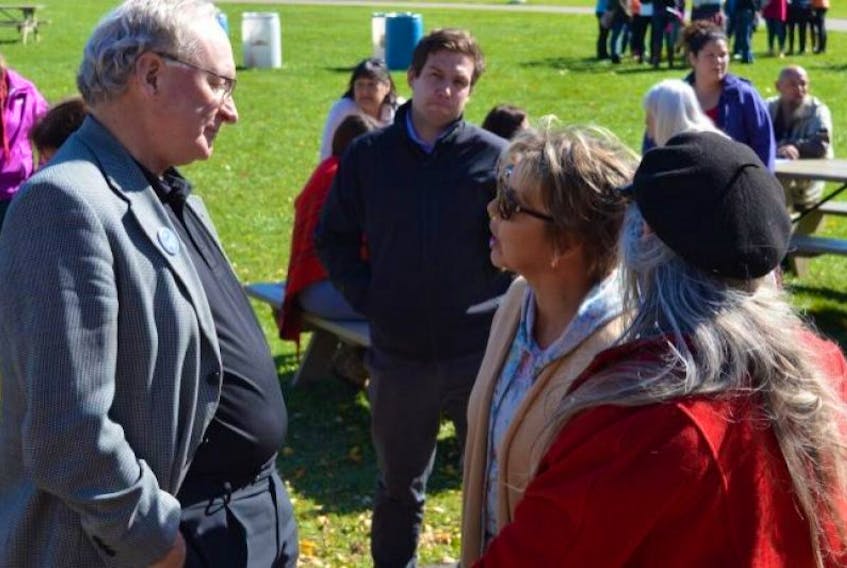 Premier Wade MacLauchlan speaks with some of the people who attended the Sisters in Spirit Vigil in Charlottetown on Tuesday, held to honour the lives of murdered and missing aboriginal women in Canada. The premier told the crowd the province will be inviting the national inquiry to come to P.E.I. to hear from the Island’s First Nation’s people. MacLauchlan is the first P.E.I. premier to attend the Sisters in Spirit Vigil in the 11 years it has been held in Charlottetown, according to an organizer.