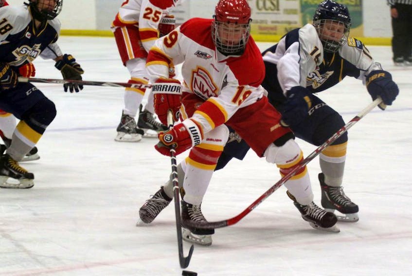 Dylan Holloway, left, of the Calgary Flames battles through a hook by Bailey Tokarz of the Ernie's Sports Experts Storm in Alberta Midget AAA Hockey League action on Oct. 8, 2016, in Grande Prairie, Alta. Holloway is ranked 12th among North American skaters by the NHL Central Scouting for 2020 NHL Entry Draft: Credit: Logan Clow/Grande Prairie Daily Herald-Tribune/Postmedia Network ORG XMIT: POS1610081632550798