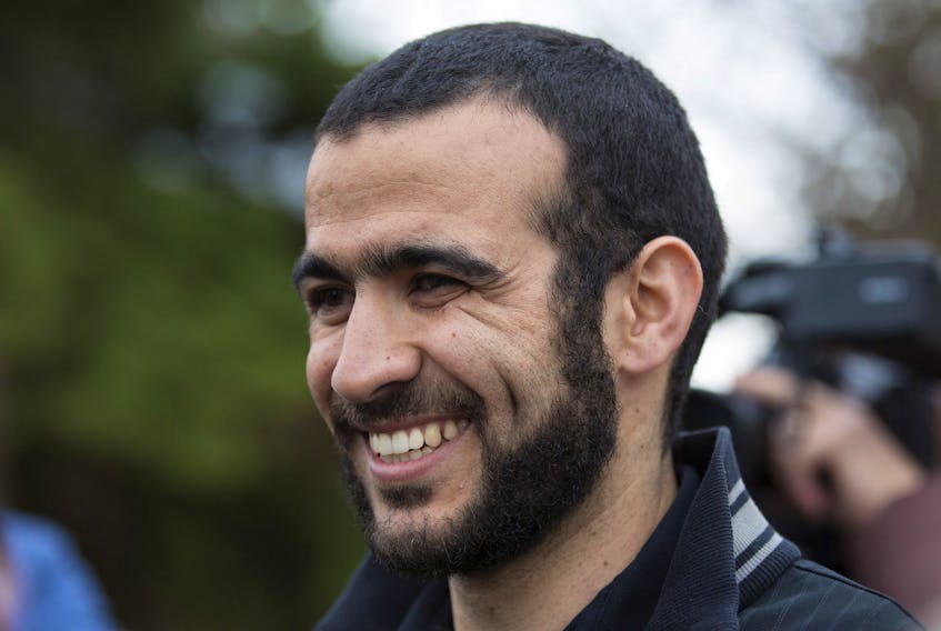 Omar Khadr smiles as he answers questions during a news conference after being released on bail in Edmonton, Alberta, May 7, 2015. Khadr, a Canadian, was once the youngest prisoner held on terror charges at Guantanamo Bay.