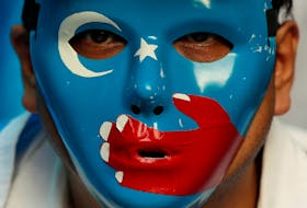 A Chinese Uyghur Muslim participates in an anti-China protest during the G20 leaders summit in Osaka, Japan on June 28. - Jorge Silva/Reuters