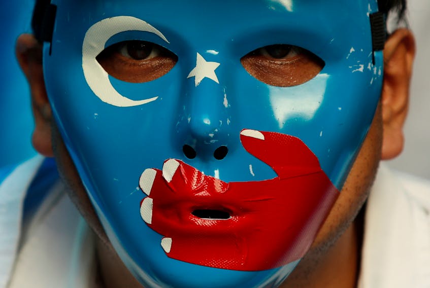 A Chinese Uyghur Muslim participates in an anti-China protest during the G20 leaders summit in Osaka, Japan on June 28. - Jorge Silva/Reuters