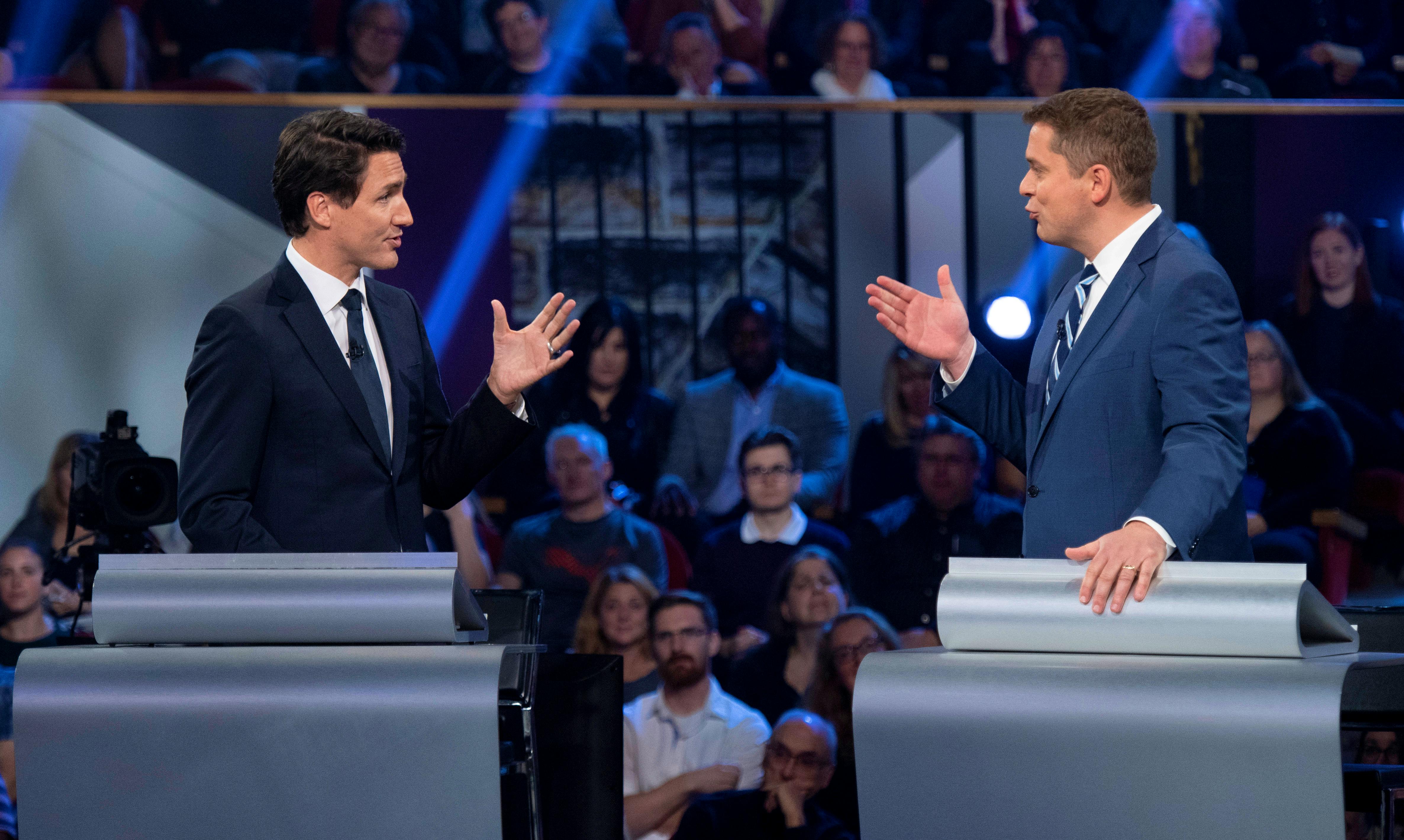 Conservative leader Andrew Scheer and Liberal leader Justin Trudeau gesture to each other as they both respond during the Federal leaders debate in Gatineau, Quebec, Canada October 7, 2019. — Justin Tang