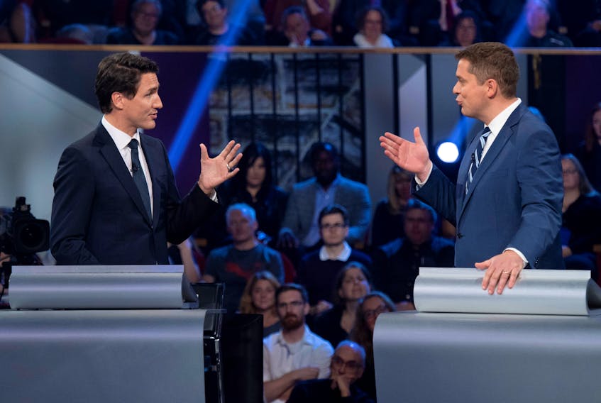 Conservative leader Andrew Scheer and Liberal leader Justin Trudeau gesture to each other as they both respond during the Federal leaders debate in Gatineau, Quebec, Canada October 7, 2019. — Justin Tang