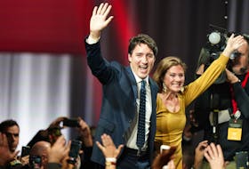 Liberal Leader Justin Trudeau and his wife Sophie Gregoire Trudeau wave to supporters early Tuesday morning, Oct. 22, 2019, at the Palais des Congres in Montreal, after his party held onto power, but with a reduced mandate in Monday's federal election. - Carlo Allegri / Reuters