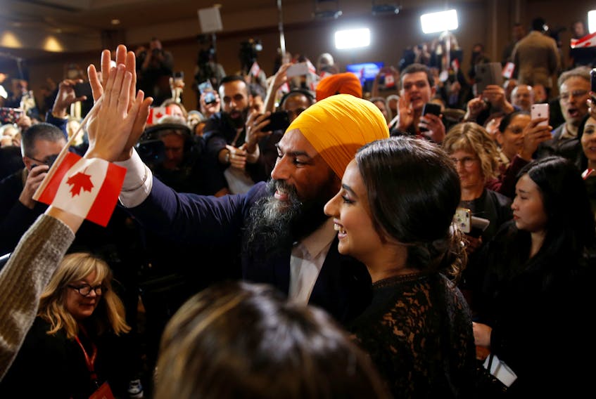 NDP Leader Jagmeet Singh and wife Gurkiran Kaur Sidhu greet supporters in Burnaby, B.C., after Singh was re-elected in Burnaby South on Monday, Oct. 21, 2019.