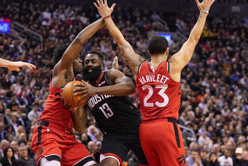 Houston Rockets guard James Harden, centre, drives between Toronto Raptors forward OG Anunoby, left, and guard Fred VanVleet, right, during the first half at Scotiabank Arena, Dec. 5, 2019. (John E. Sokolowski-USA TODAY Sports)
