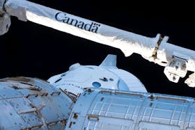 The Canadarm2 robotic arm, built by Canadian technology company MDA, is seen over the uncrewed SpaceX Crew Dragon spacecraft as it makes the first Commercial Crew vehicle to visit the International Space Station March 4, 2019. - NASA / Handout via Reuters
