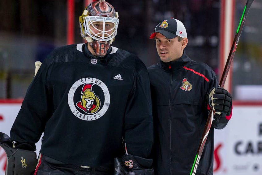Ottawa Senator goaltender Marcus Hogberg with goaltending coach Pierre Groulx during team practice at the Canadian Tire Centre. December 13, 2019. 