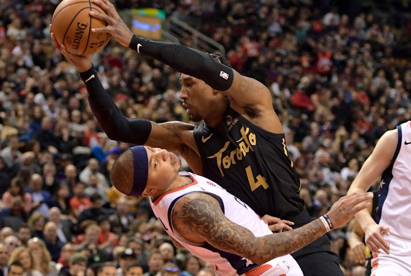 Toronto Raptors forward Rondae Hollis-Jefferson, right, drives to the basket and collides with Washington Wizards guard Isaiah Thomas in the fourth quarter at Scotiabank Arena in Toronto, Jan. 17, 2020. (Dan Hamilton-USA TODAY Sports)