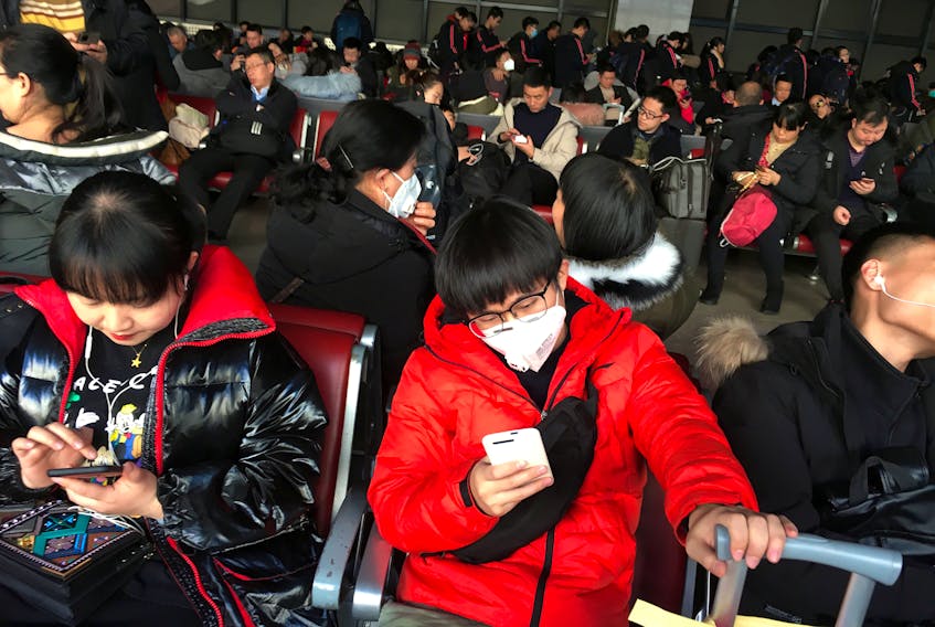 Passengers wearing masks are seen at the waiting area for a train to Wuhan at the Beijing West Railway Station, ahead of the Chinese Lunar New Year, in Beijing, China January 20, 2020.