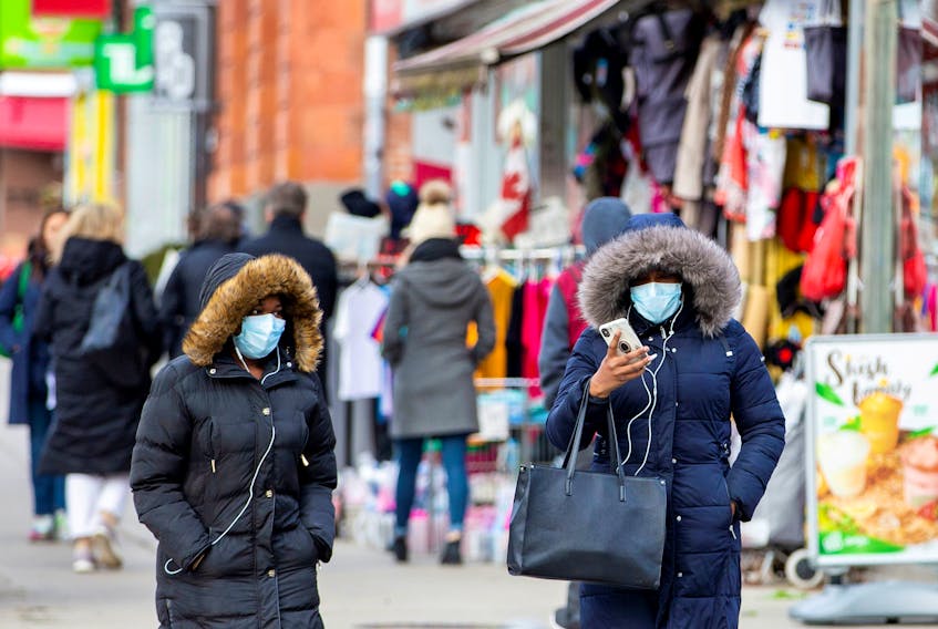 Pedestrians walk in the Chinatown district of downtown Toronto on Jan. 28, 2020.