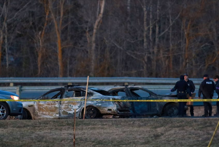 RCMP officers go over a car collision scene involving the fake RCMP car driven by Gabriel Wortman in Shubenacadie, N.S., April 19, 2020.