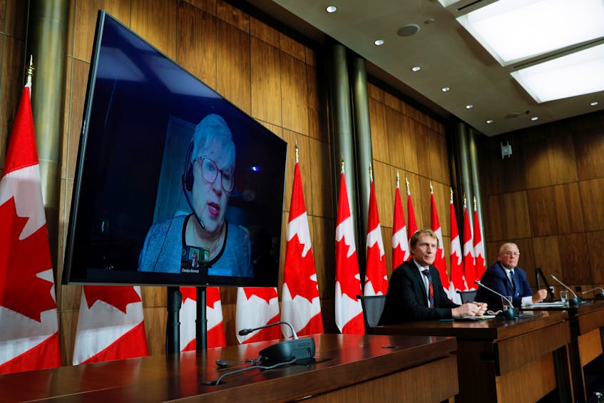 Federal Fisheries Minister Bernadette Jordan (on screen), Indigenous Services Minister Marc Miller and Public Safety Minister Bill Blair take part in a news conference about the dispute between Nova Scotia commercial and Mi'kmaw lobster fishers, on Parliament Hill in Ottawa on Monday, Oct. 19, 2020.