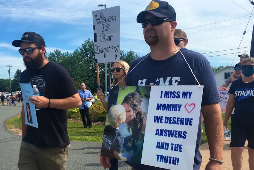 Nick Beaton (right), Kristen Beaton's husband, leads hundreds of people on a march to the RCMP detachment in Bible Hill on Wednesday, July 22, 2020, as an effort to keep the pressure on the provincial and federal governments to call a public inquiry into the mass shooting on April 18 and 19