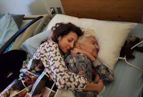 In a photo she recovered from her phone Tuesday night, Liz Morris cuddles with her mother Nancy Georgina before she died of pancreatic cancer in January.
