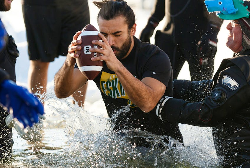 Edmonton Eskimos wide receiver Diego Jair Viamontes Cotera jumps in during the 2020 Polar Plunge at Lake Summerside on Jan. 26, 2020, in support of the Law Enforcement Torch Run (LETR) for Special Olympics Alberta.