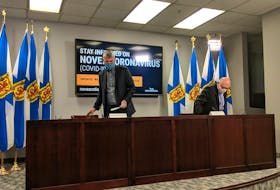Nova Scotia Premier Stephen McNeil, left, and Dr. Robert Strang, chief public health officer of health, arrive at a COVID-19 news briefing on Wednesday in Halifax.