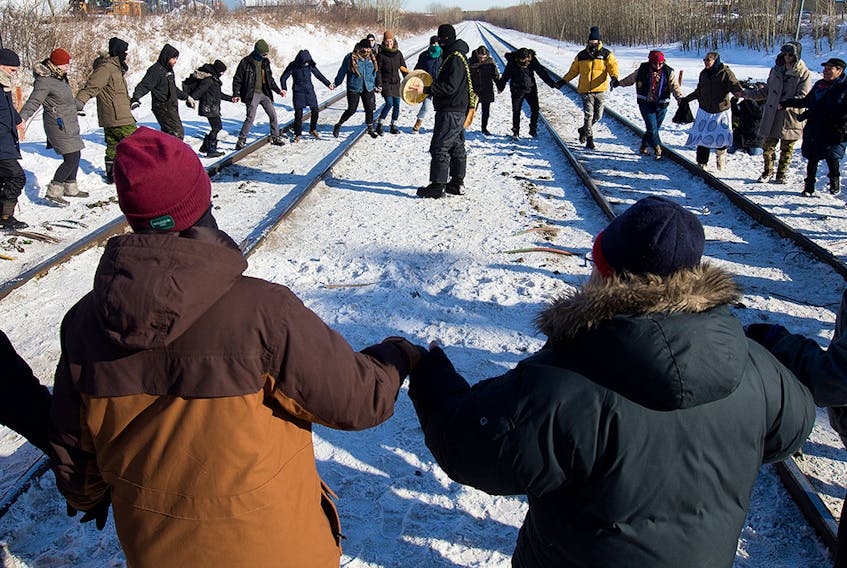 Protesters perform a round dance as they prepare to end their blockade at the CN rail line near 213 Street and 110 Avenue in solidarity with Wet'suwet'en Hereditary Chiefs, in Edmonton Wednesday Feb. 19, 2020. 