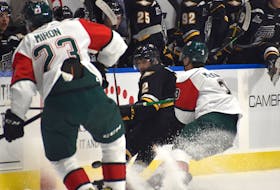 François-James Buteau of the Cape Breton Eagles middle, spins off a check from Dylan MacKinnon of the Halifax Mooseheads, right, during Quebec Major Junior Hockey League action at Centre 200, Friday. Halifax won the game 3-2. JEREMY FRASER/CAPE BRETON POST.