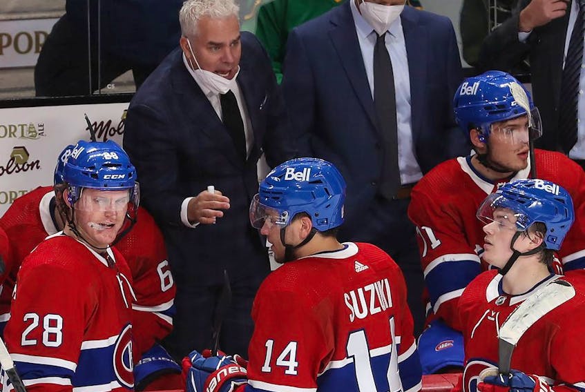 Montreal Canadiens coach Dominique Ducharme talks to his players during a timeout in overtime  in NHL action in Montreal on Thursday October 07, 2021. 