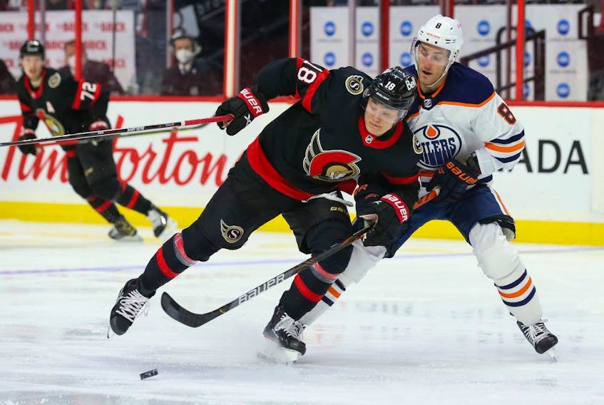 Tim Stützle (18) of the Ottawa Senators battles for the puck against Kyle Turris (8) of the Edmonton Oilers at Canadian Tire Centre on April 7, 2021, in Ottawa. 