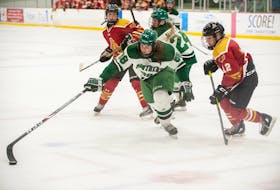 Jolena Gillard of the UPEI Panthers reaches the puck during an Atlantic University Sport women’s hockey game against the Mount Allison Mounties at MacLauchlan Arena on Oct. 9. Chelsea Krahenbil, right, pressures Gillard while UPEI’s Mireille Martin and unidentified Mount Allison player follow the play. Gillard had two goals and two assists to lead the Panthers to a 4-1 victory. UPEI Athletics Photo
