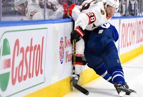 Senators' Connor Brown (28) is bodychecked by Toronto Maple Leafs defenceman Jake Muzzin in a pre-season game. 
