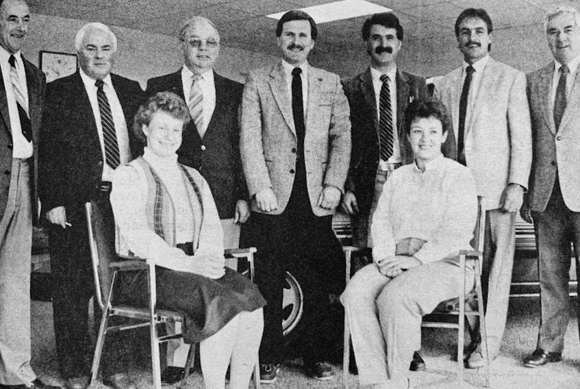 Pothier Motors celebrated its 25th anniversary in 1986 by opening a new showroom in Falmouth. Gathered for a sales and office staff shot were, from left, standing: Tom Pothier, Ernie Spencer, Bernie Grant, Brian Redden, Randy Shield, John Pothier, and Carl (Chook) Smith; seated: Lynn Porter and Pat Skelhorn.