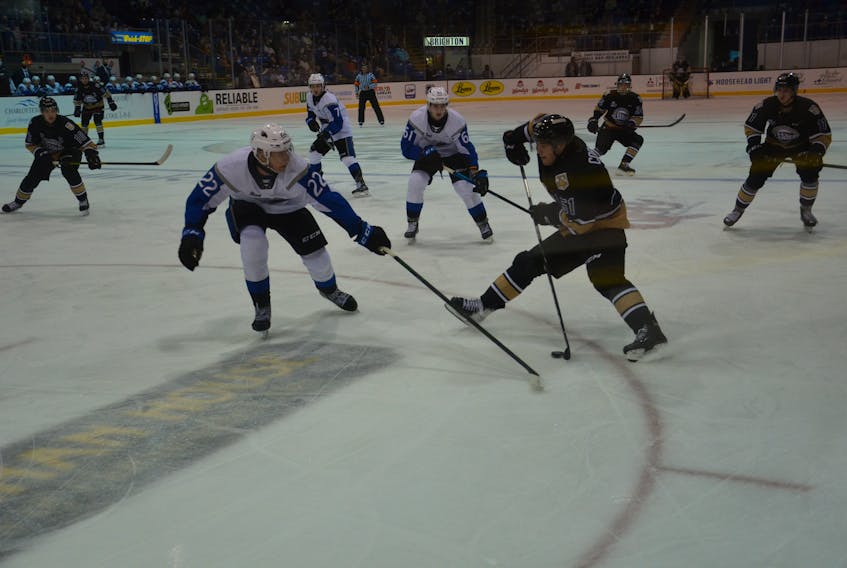 Charlottetown Islanders defenceman Lukas Cormier, 51, looks to avoid the stick of Saint John Sea Dogs defenceman Vincent Despont during a Quebec Major Junior Hockey League game at Eastlink Centre on Oct. 11. The Sea Dogs defeated the Islanders 3-1.