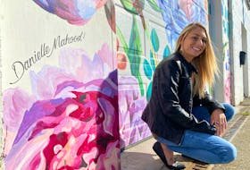 Danielle Mahood by her Jenesis Interiors mural on Water Street.
CARLA ALLEN • TRI-COUNTY VANGUARD