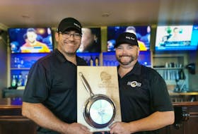 Quentin Gillis, left, owner-operator of Holy Cow, and chef Aaron Ferrill hold the winner's plaque after their burger, The Lone Ranger, was named the winner of the 2021 P.E.I. Burger Love campaign. Gillis said despite a few issues, the campaign was a success for them. Contributed