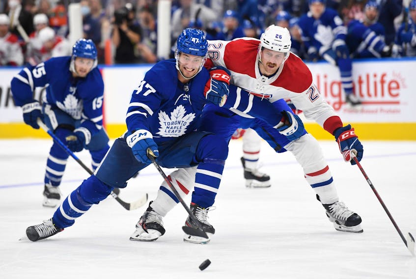 Maple Leafs' Pierre Engvall (left) pursues the puck ahead of Montreal Canadiens' Jeff Petry during the second period at Scotiabank Arena on Wednesday, Oct. 13, 2021. 