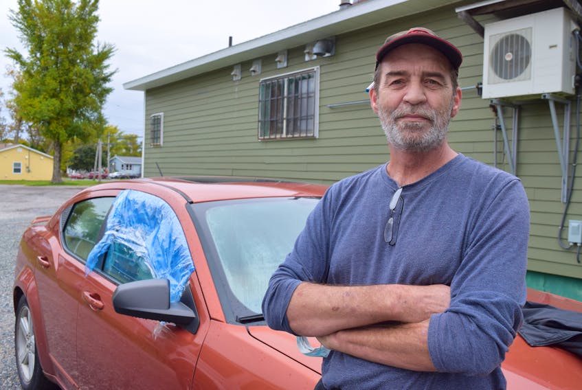 John Patrick, 57, stands outside his car he has been living in behind a store in Sydney since the first of summer. Patrick credits kindness of the store owner and neighbours for making his homeless situation more bearable. Sharon Montgomery-Dupe/Cape Breton Post
