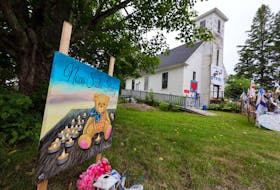 July 23, 2020—Items of condolence overflow on the steps and yard in front of the old Portapique Church. The commission of inquiry investigating the mass killing is delaying hearings scheduled for October until late January. 
ERIC WYNNE/Chronicle Herald