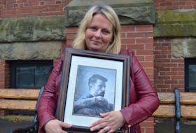 Shari Affleck holds a picture of her son, Luke Allen, who died last month following complications from a double lung transplant he had in 2019.