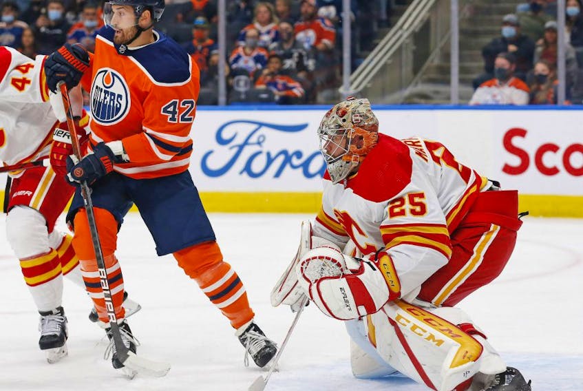 Edmonton Oilers forward Brendan Perlini (42) looks for a puck in front of Calgary Flames goaltender Jacob Markstrom (25) during the first period at Rogers Place. 