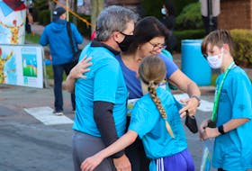 Brenda Simmons hugs her supporters after finishing one of Saturday, Oct. 16's events at the 2021 P.E.I. Marathon. The Marathon weekend runs from Oct. 15-17.