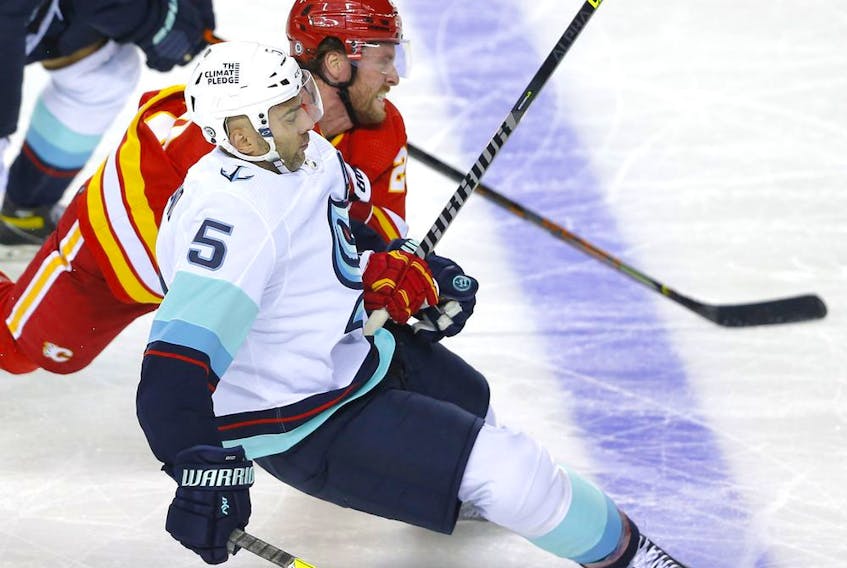 The Calgary Flames’ Blake Coleman battles the Seattle Kraken’s Mark Giordano in pre-season action at the Scotiabank Saddledome in Calgary on Wednesday, Sept. 29, 2021. 