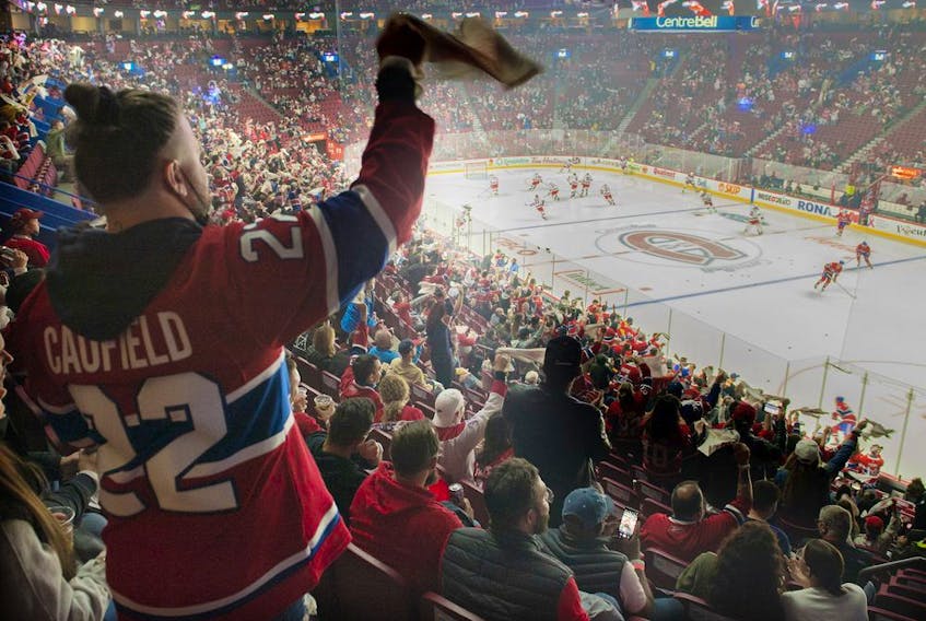 Canadiens fans cheer on the team during pre-game warmup Saturday night at the Bell Centre.
