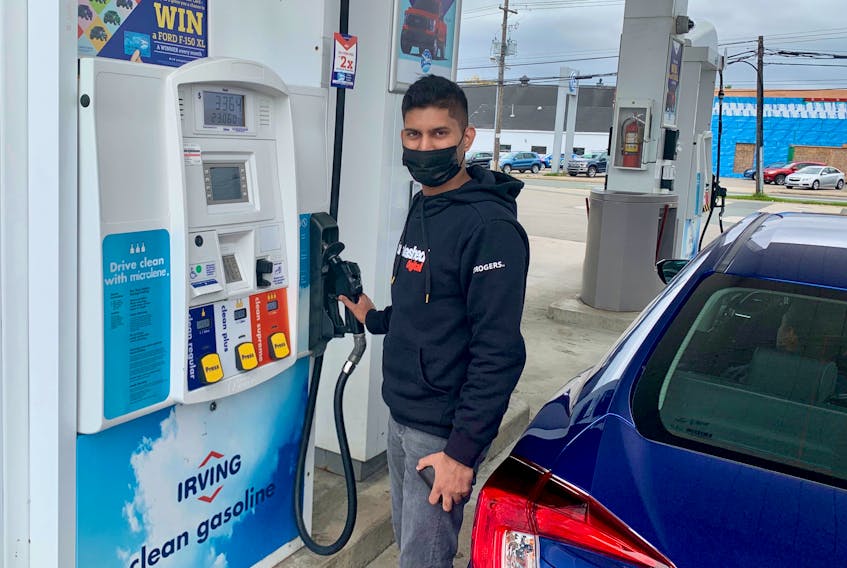 Urvesh Boodhun fuels up at a Sydney service station. The Charlottetown resident needed to top off the tank after spending the weekend touring Cape Breton. Like other drivers utilizing area self-serve pumps, Boodhun paid $1.45.9 per litre. DAVID JALA/CAPE BRETON POST