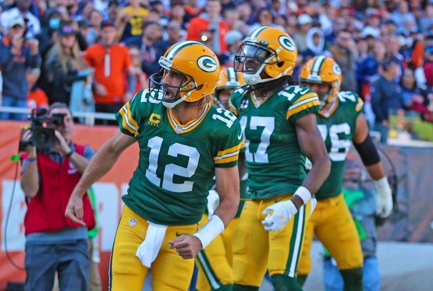 Green Bay Packers quarterback Aaron Rodgers (12) celebrates scoring a touchdown during the second half against the Chicago Bears at Soldier Field.