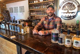 Andrew Cameron, co-owner of Still Fired, stands at the distillery's bar in Annapolis Royal.