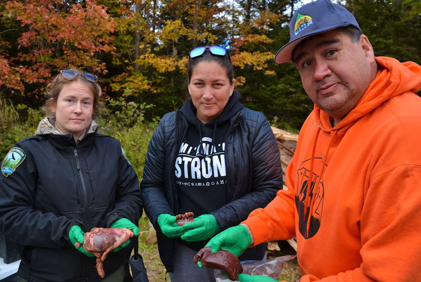 Parts of the moose hunters bring back can give researchers information about the general age and health of the moose population. Pictured from left are forestry technician Stephanie Gordon holding a moose heart, Carolyn Stevens from Mi'kmaq Rights Initiative with the jaw, and UINR's moose management coordinator Clifford Paul holding the liver. ARDELLE REYNOLDS/CAPE BRETON POST