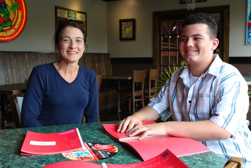 Jody Holley and her son Luke Reddick at Jungle Jim's, using the braille and QR code menus.  