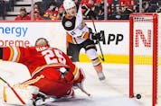 The Anaheim Ducks’ Jamie Drysdale scores in overtime against Calgary Flames goaltender Jacob Markstrom at Scotiabank Saddledome on Monday, Oct. 18, 2021. 