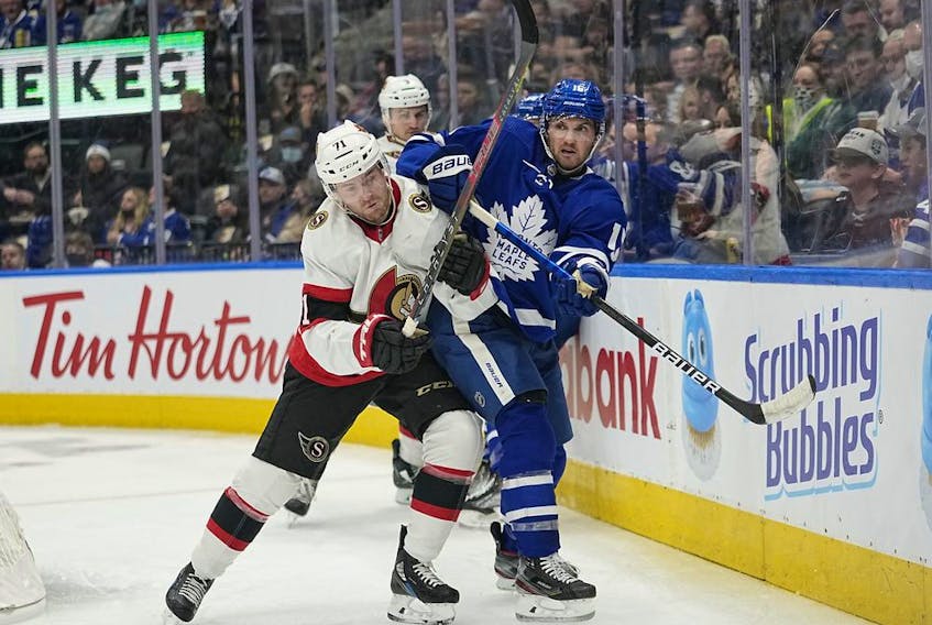  Ottawa Senators forward Chris Tierney (71) and Toronto Maple Leafs forward Alexander Kerfoot (15) battle for position during the second period at Scotiabank Arena, Oct. 16, 2021.