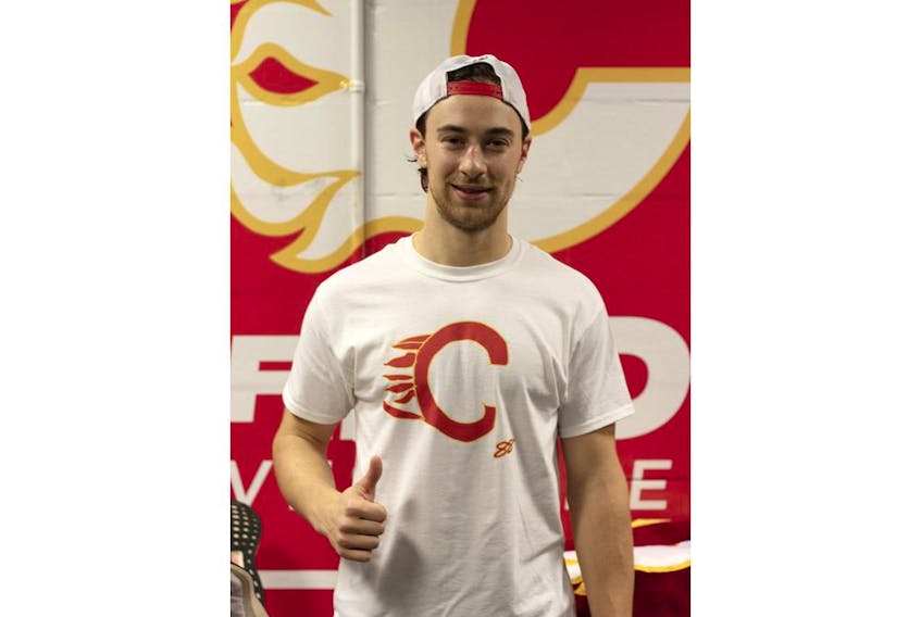 Andrew Mangiapane models a T-shirt that features his hand-drawn attempt at the Calgary Flames’ logo. The shirts are now for sale through the team store, with all proceeds to Mangiapane’s charity of choice — the Hotchkiss Brain Institute. 