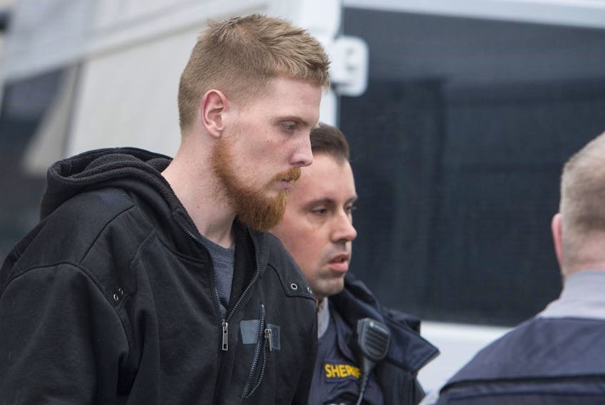 Brandon Jake Hollohan is escorted into the Dartmouth courthouse in January 2018 to face a charge of second-degree murder in the killing of Deborah Irene Yorke. The Crown has applied to revoke his bail in Nova Scotia Supreme Court.